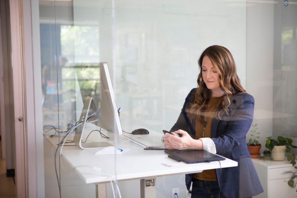 Founder reviewing marketing strategy at a standing desk in a modern office